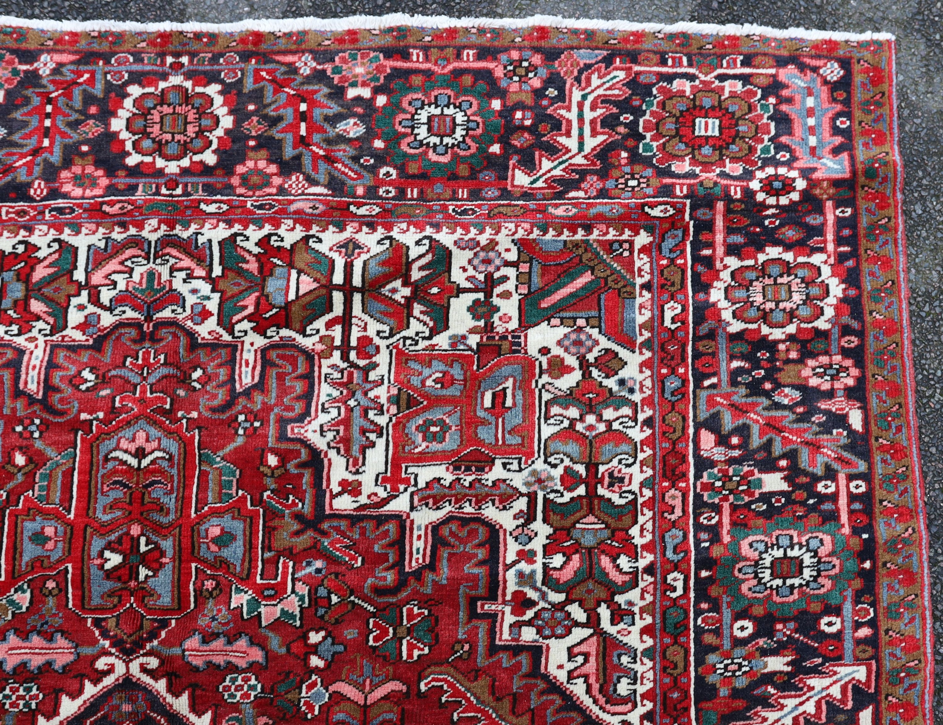 A Heriz red ground carpet, 324 x 243cm.